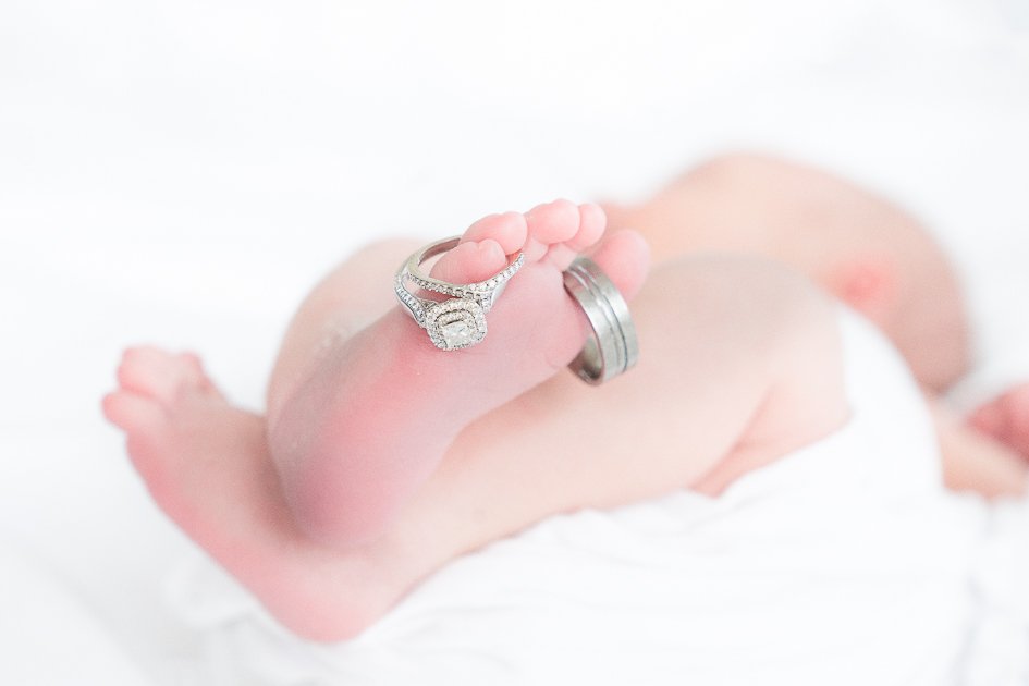 baby feet with wedding rings
