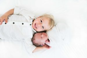baby photographer shows baby boy with brother